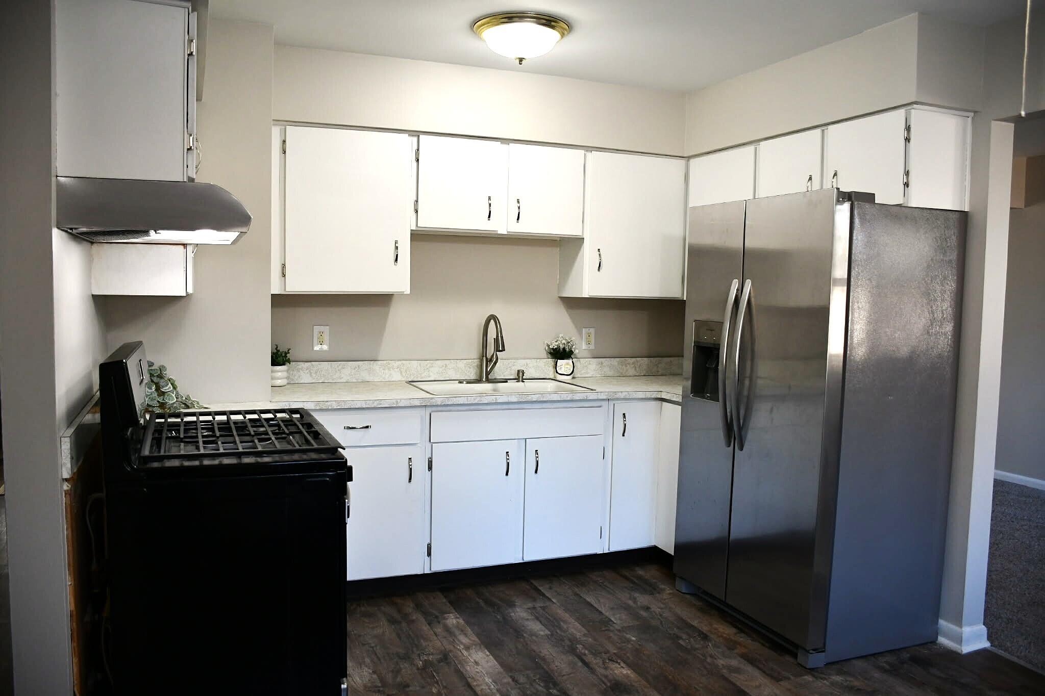 1645 Tulip Lane Munster, IN 46321 - Photo 7 of 23 a kitchen with a refrigerator a sink and cabinets