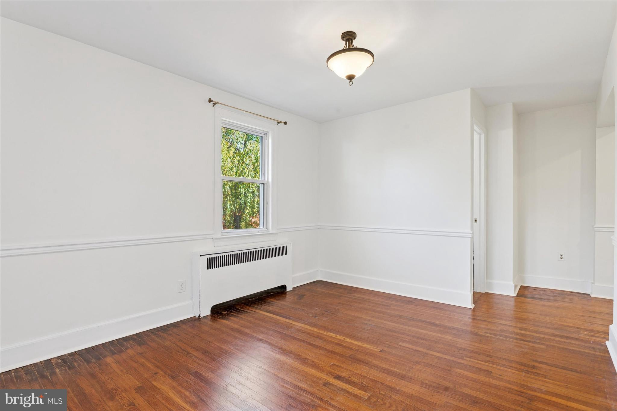 25 Green Valley Road Wallingford, PA 19086 - Photo 24 of 63 an empty room with wooden floor and windows