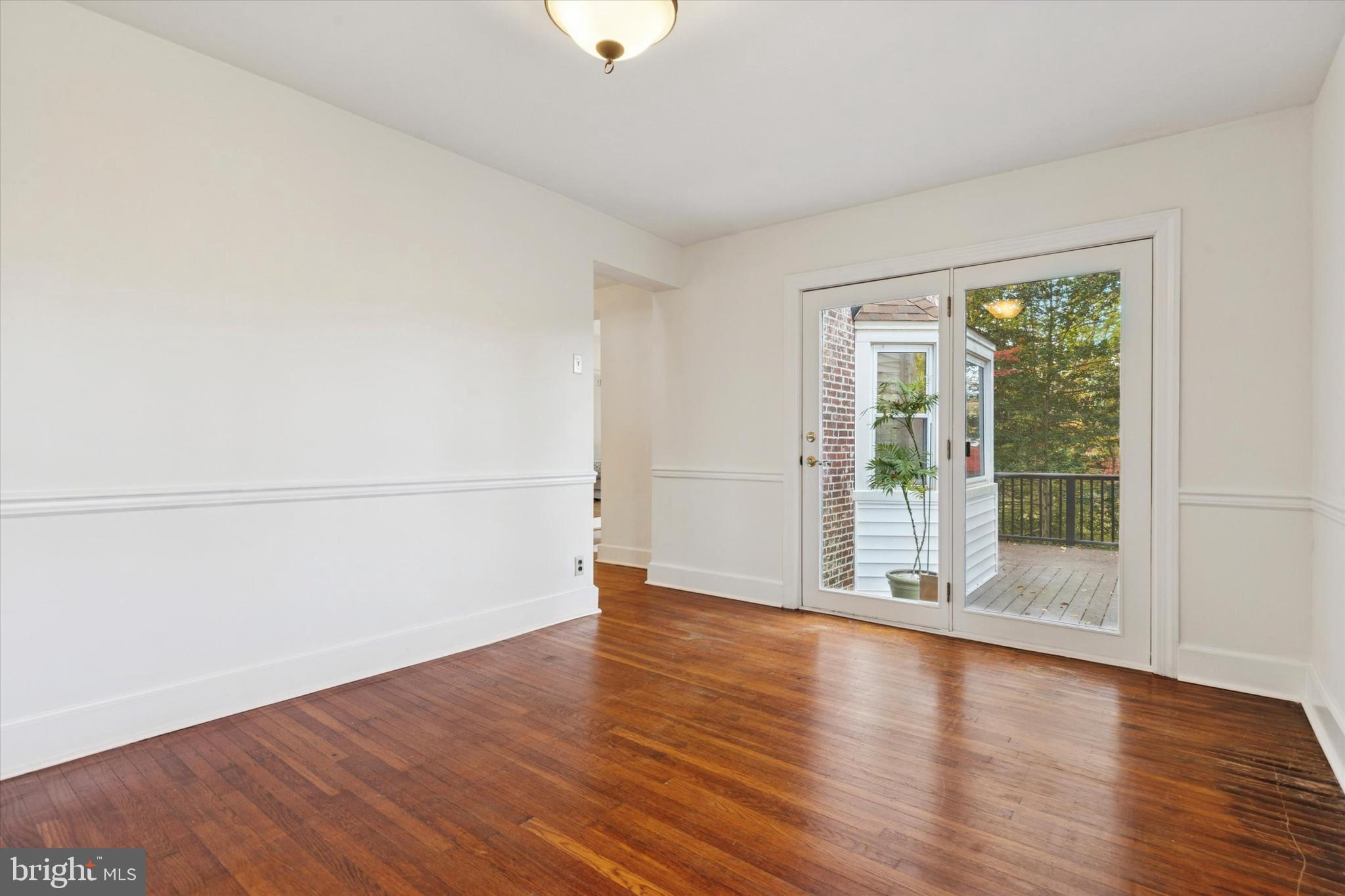 25 Green Valley Road Wallingford, PA 19086 - Photo 25 of 63 an empty room with wooden floor and windows