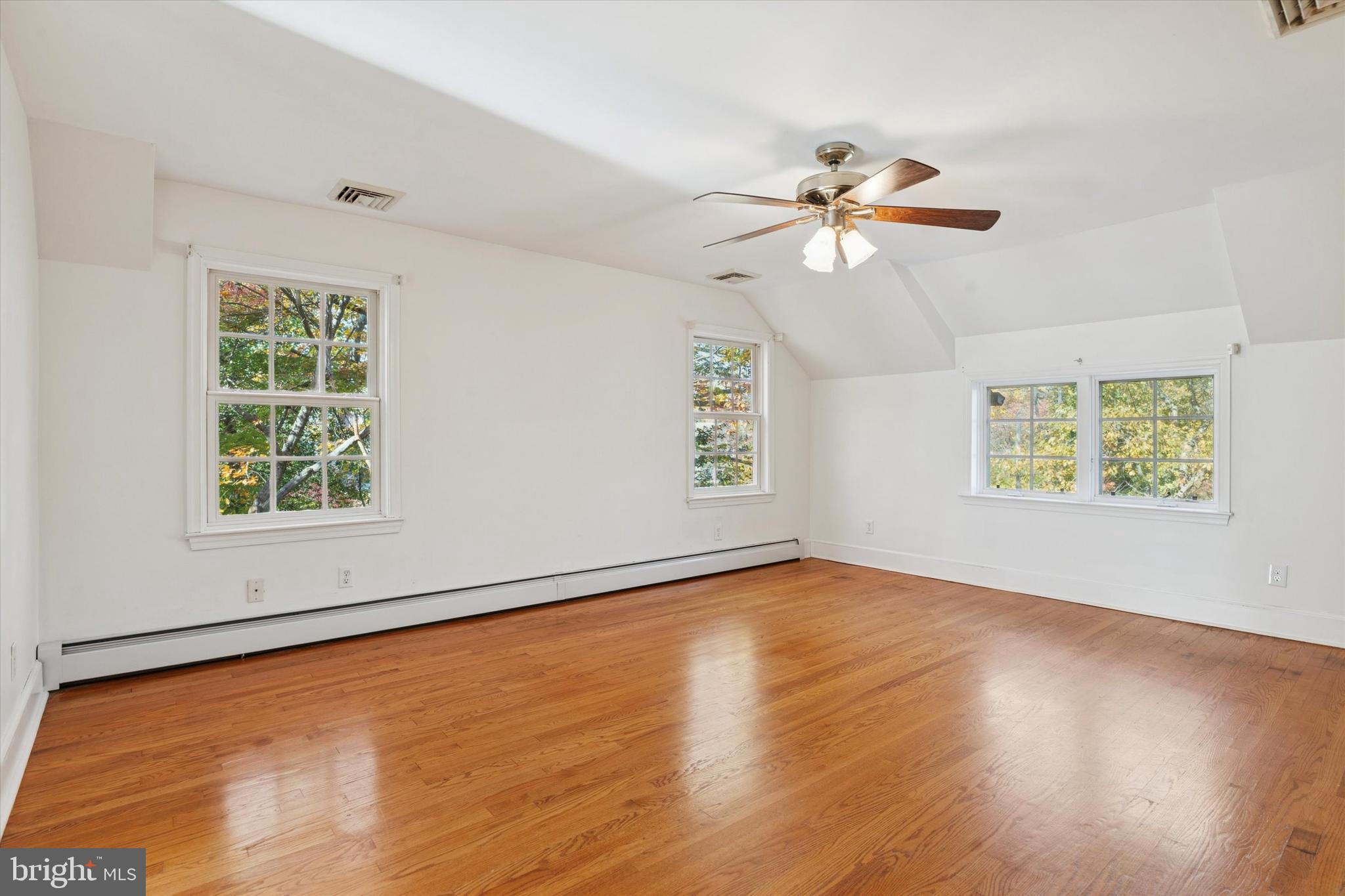25 Green Valley Road Wallingford, PA 19086 - Photo 39 of 63 wooden floor in an empty room with a window