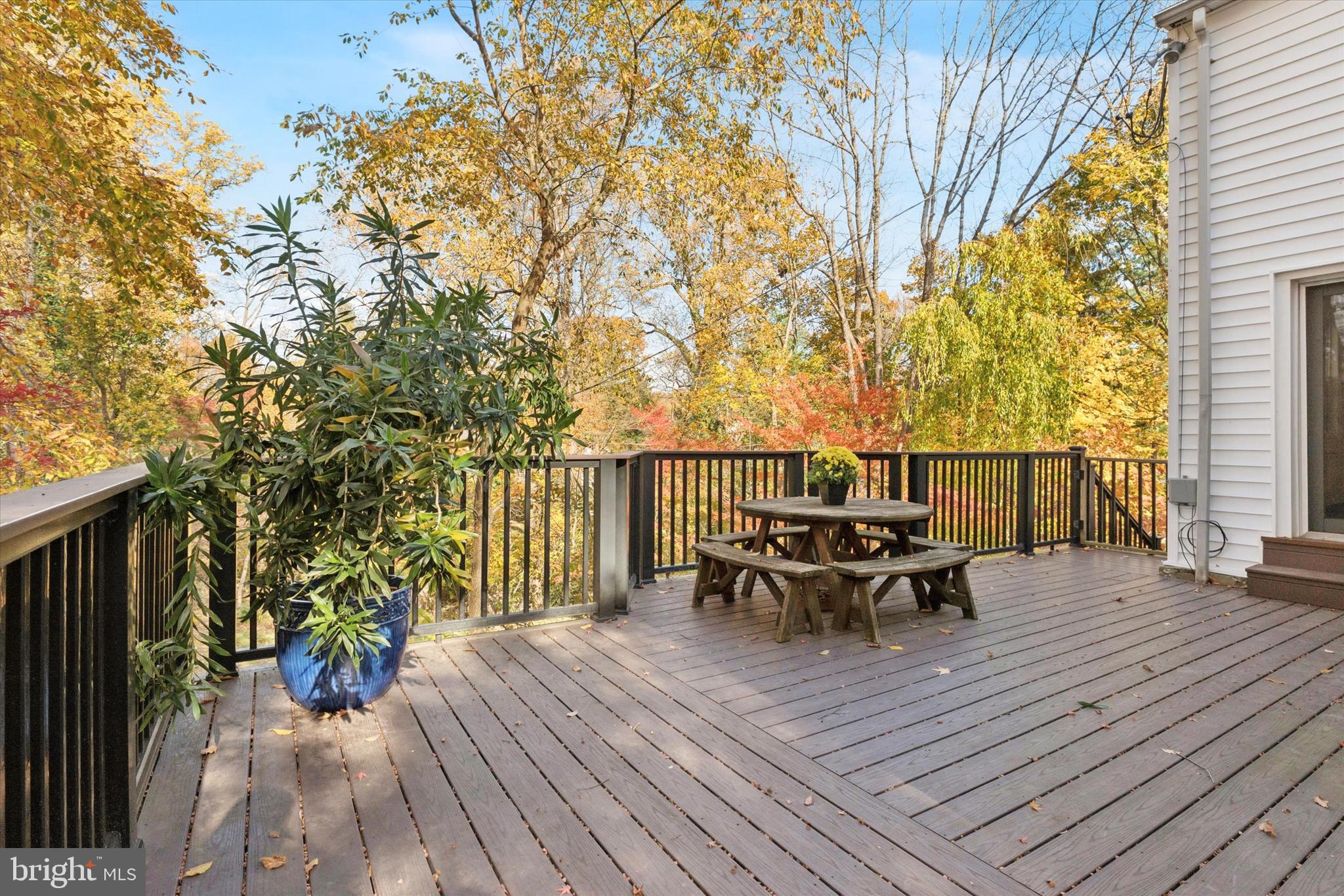 25 Green Valley Road Wallingford, PA 19086 - Photo 47 of 63 a view of a deck with table and chairs and wooden floor