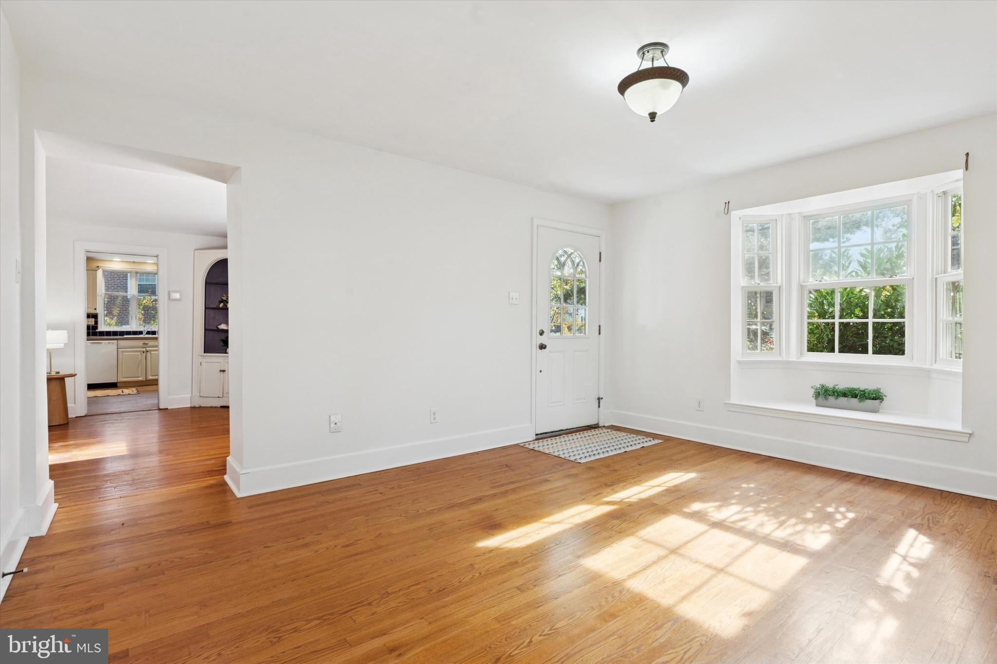 25 Green Valley Road Wallingford, PA 19086 - Photo 5 of 63 a view of empty room with wooden floor and fan