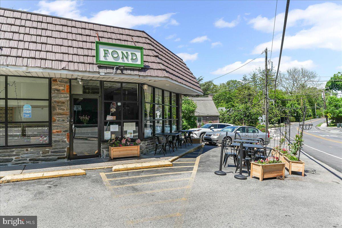 25 Green Valley Road Wallingford, PA 19086 - Photo 56 of 63 a view of a patio with a table and chairs and potted plants