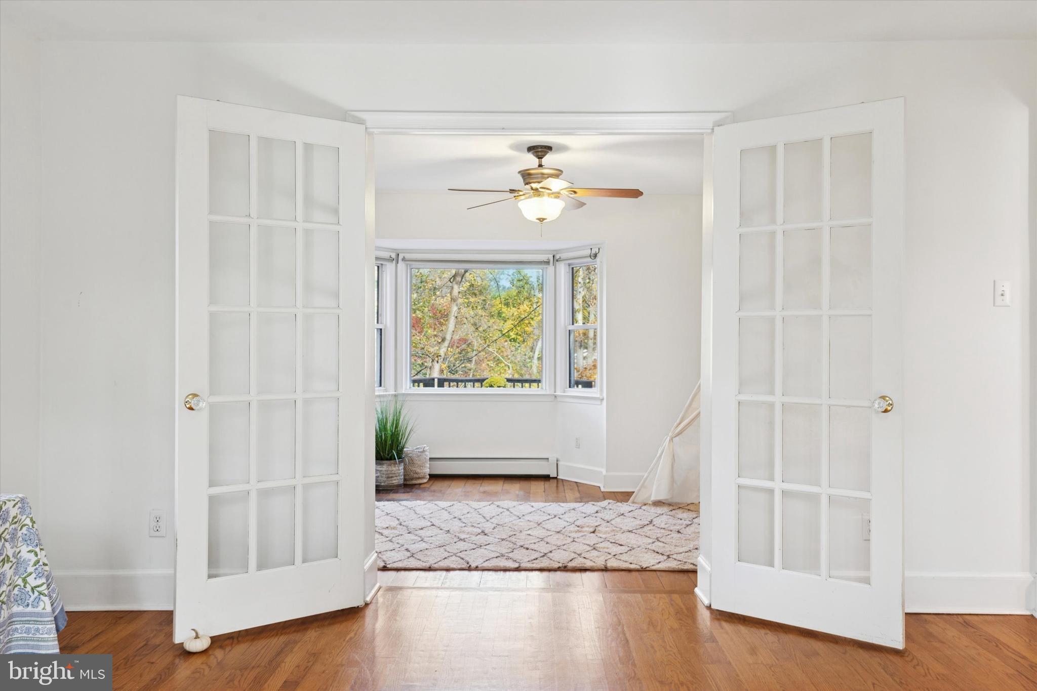 25 Green Valley Road Wallingford, PA 19086 - Photo 9 of 63 an empty room with wooden floor and cabinet