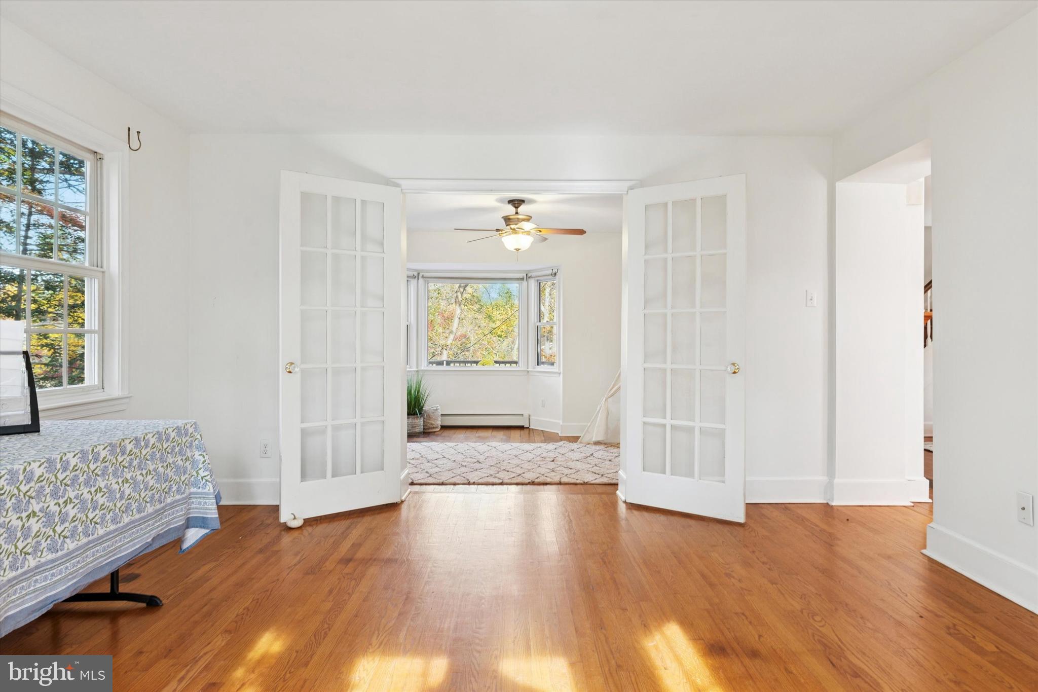25 Green Valley Road Wallingford, PA 19086 - Photo 10 of 63 a view of an empty room and window with wooden floor