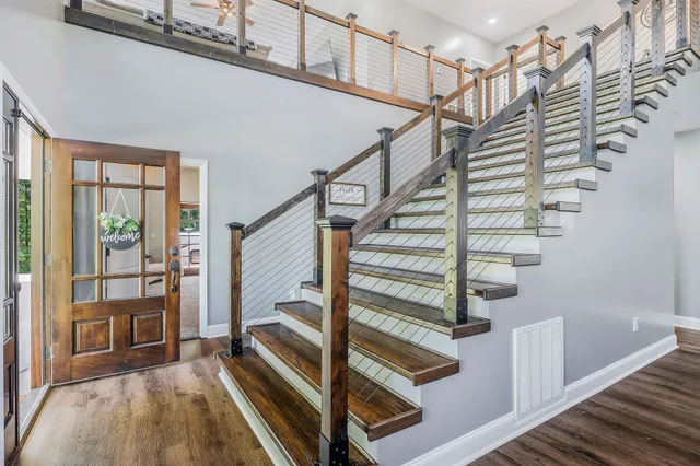 a living room with lots of furniture and kitchen view