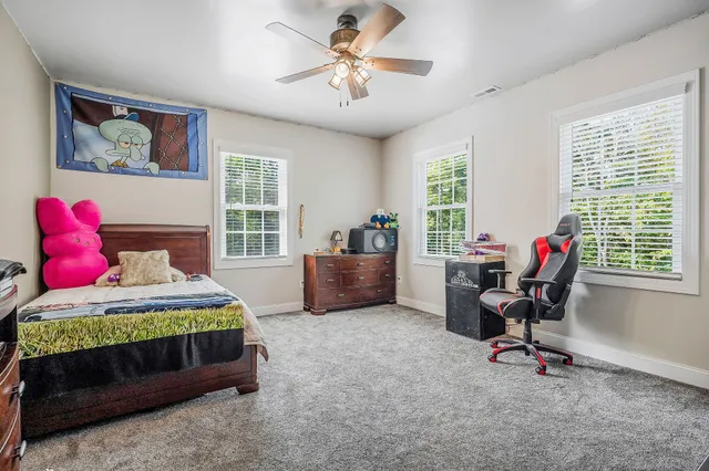 an aerial view of a house with a yard and outdoor seating