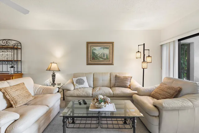 a living room with furniture and a lamp