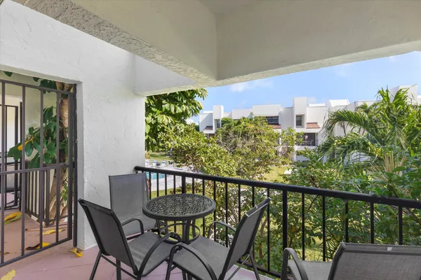 a view of a balcony with chairs