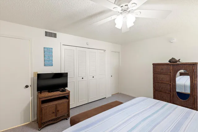 a bedroom with a bed and a television