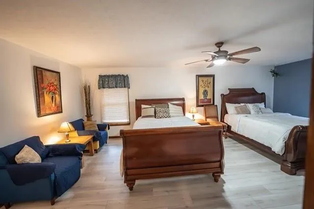 a bedroom with a bed couch and window