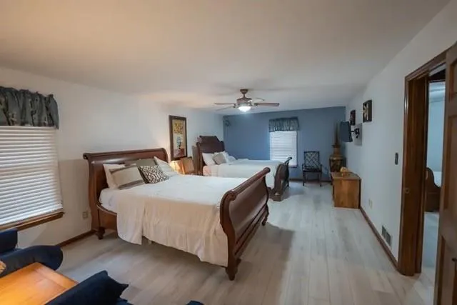 a spacious bedroom with a bed and a chandelier