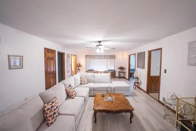 a living room with furniture and a chandelier