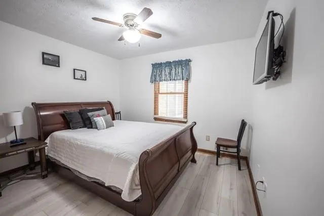 a bed room with a bed and a chair