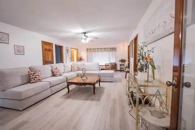 a living room with furniture and wooden floor
