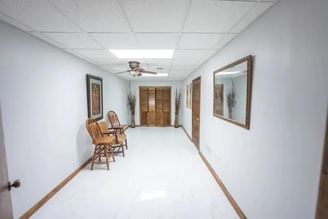 a view of a hallway with furniture and a window