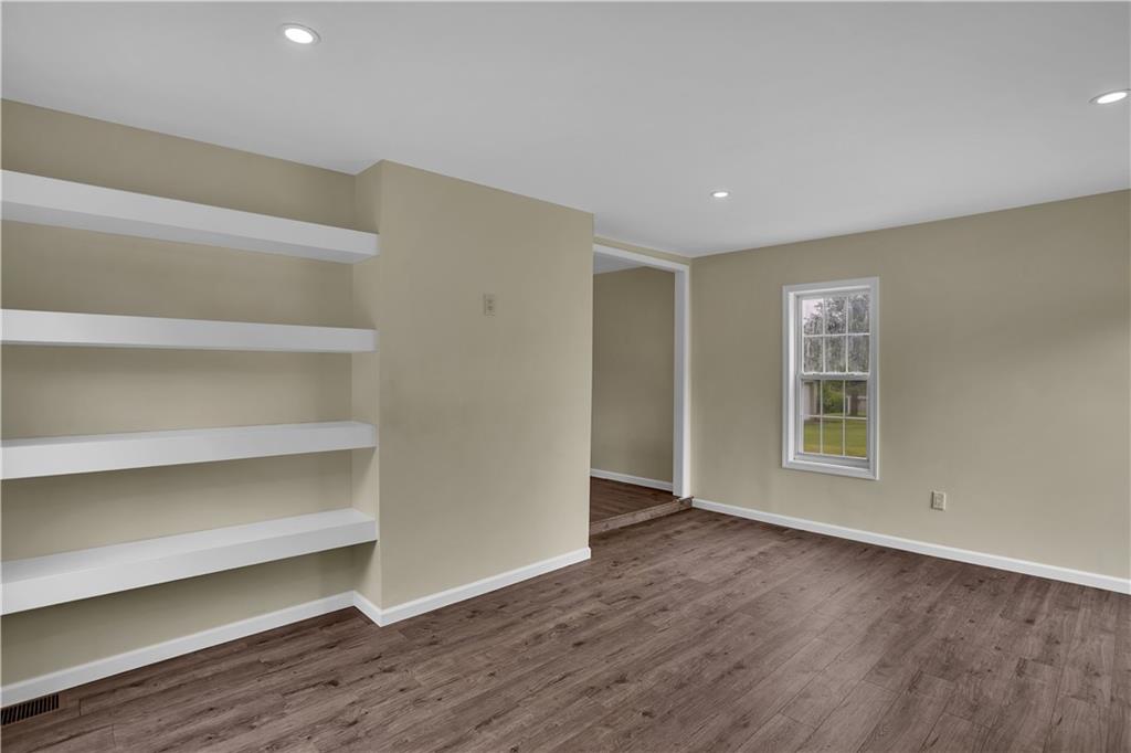 46 Terrace Road Millsboro, PA 15348 - Photo 17 of 32 a view of an empty room with a window and wooden floor
