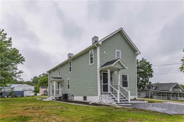 a front view of house with yard and swimming pool