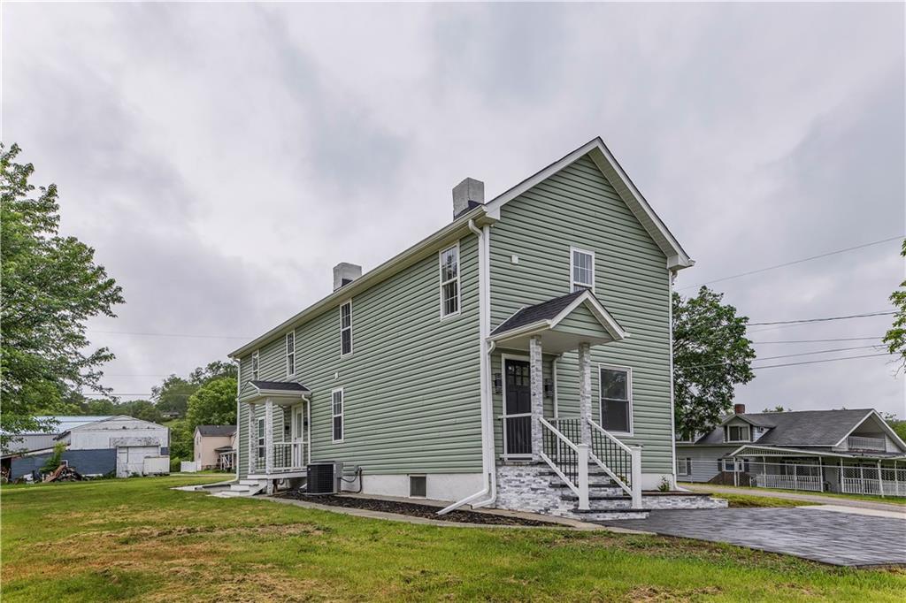 46 Terrace Road Millsboro, PA 15348 - Photo 2 of 32 a front view of house with yard and swimming pool