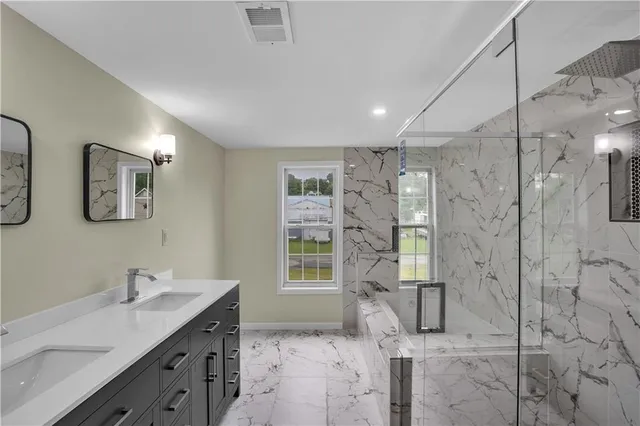 a bathroom with a bathtub and shower