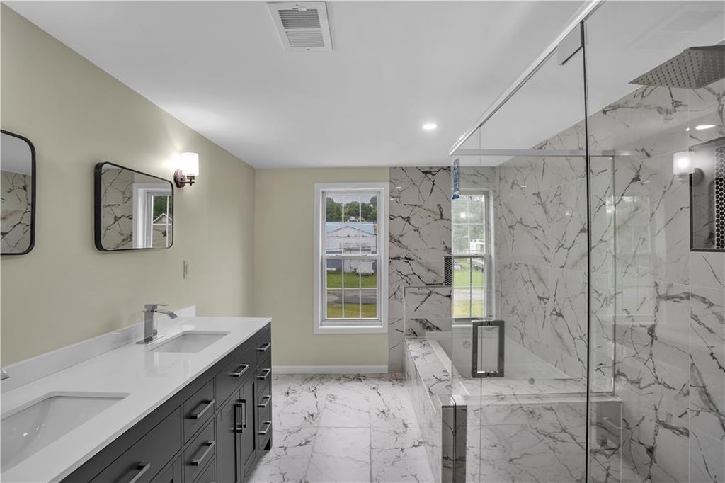 46 Terrace Road Millsboro, PA 15348 - Photo 24 of 32 a bathroom with a granite countertop sink a shower a mirror and a shower