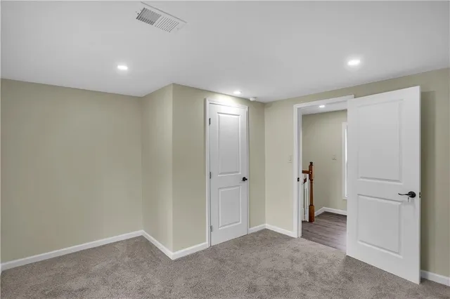 a utility room with a stove and wooden floor