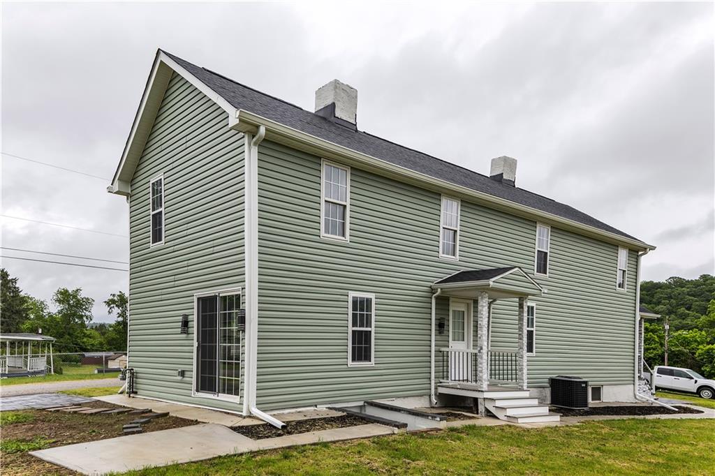 46 Terrace Road Millsboro, PA 15348 - Photo 3 of 32 a front view of a house with a yard