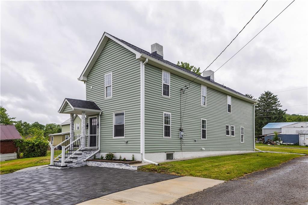 46 Terrace Road Millsboro, PA 15348 - Photo 4 of 32 a front view of a house with garden