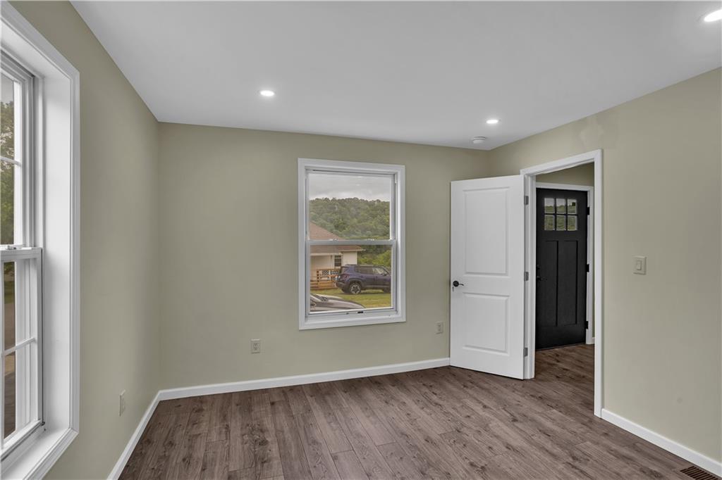 46 Terrace Road Millsboro, PA 15348 - Photo 6 of 32 an empty room with wooden floor and windows