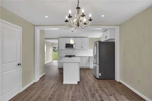 a view of a kitchen with a sink and refrigerator