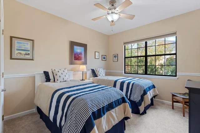 a bedroom with two beds and a window