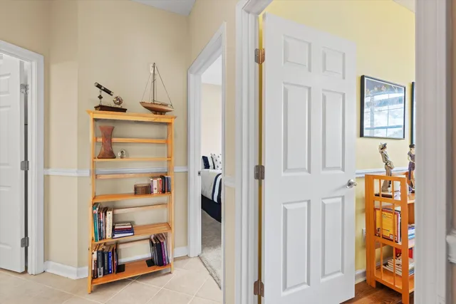 a living room with furniture and a book shelf