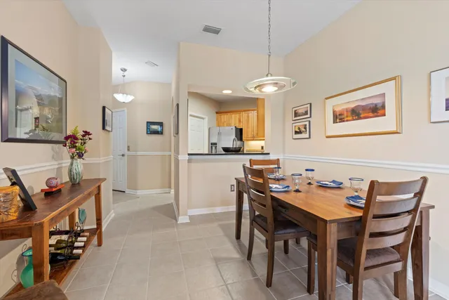 a view of a dining room with furniture and a chandelier