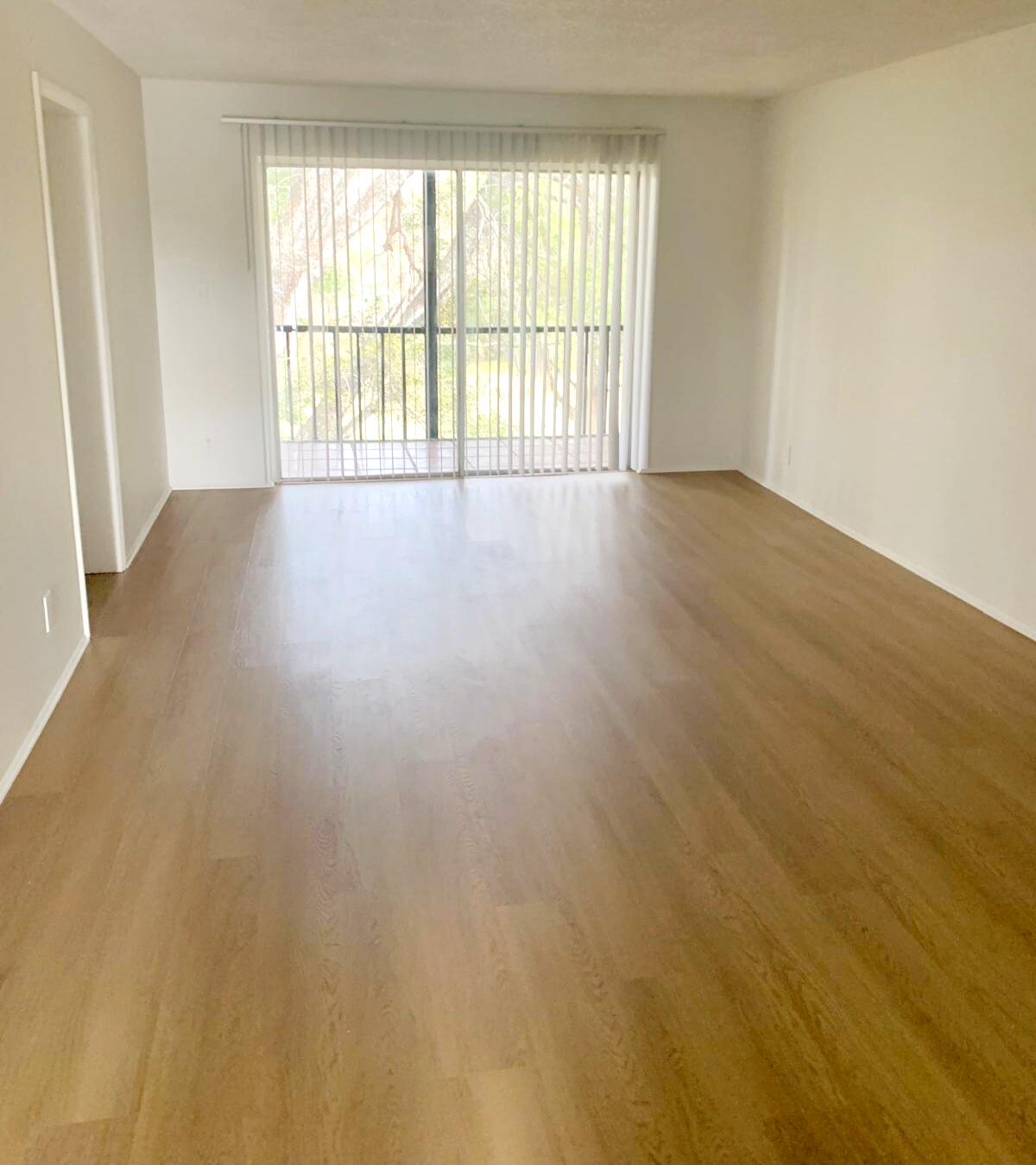 7911 North Colony Circle, Unit 305 Tamarac, FL 33321 - Photo 13 of 49 wooden floor in an empty room with a window