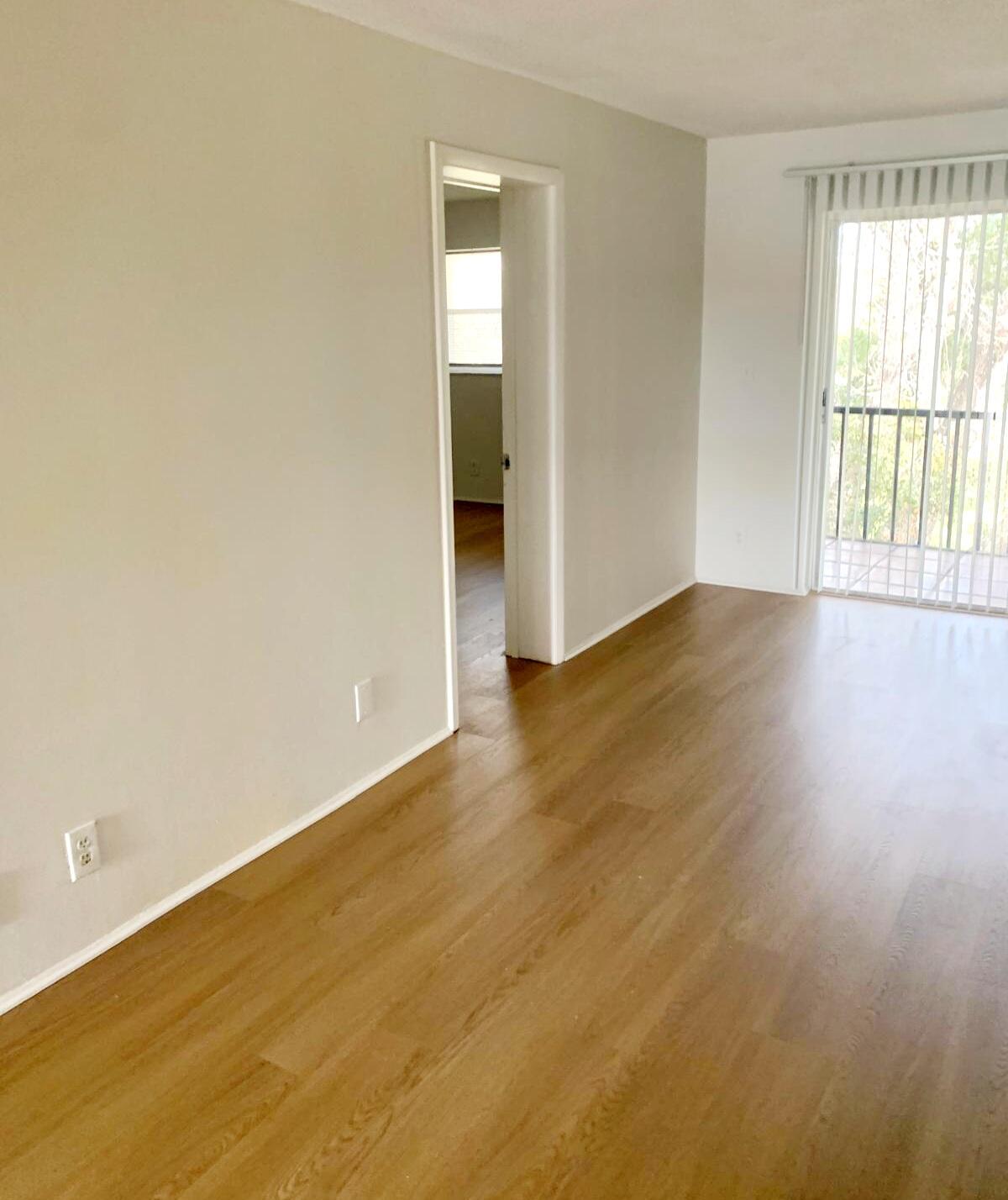 7911 North Colony Circle, Unit 305 Tamarac, FL 33321 - Photo 16 of 49 a view of an empty room with wooden floor and a window