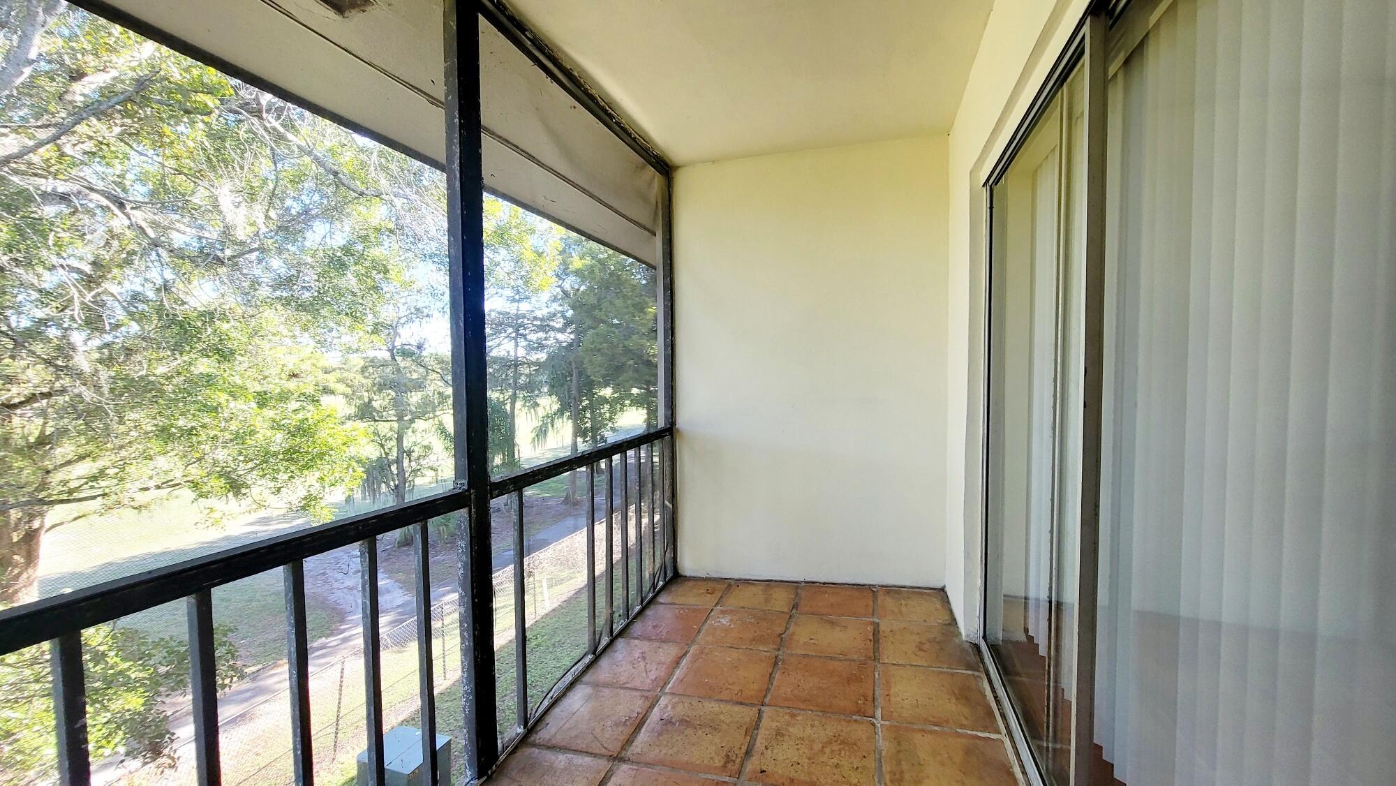 7911 North Colony Circle, Unit 305 Tamarac, FL 33321 - Photo 19 of 49 a view of a balcony with wooden floor