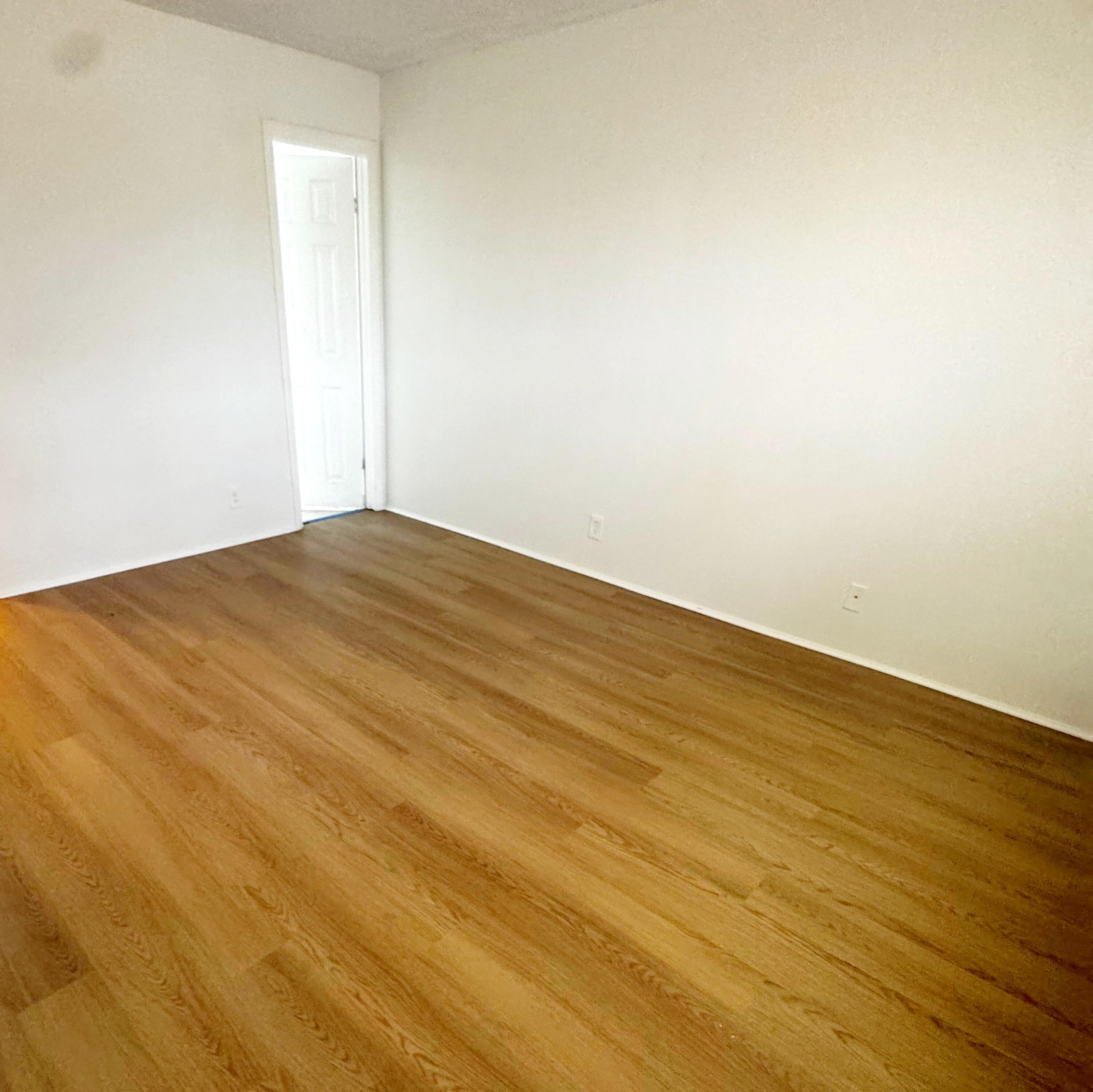 7911 North Colony Circle, Unit 305 Tamarac, FL 33321 - Photo 23 of 49 a view of empty room with wooden floor