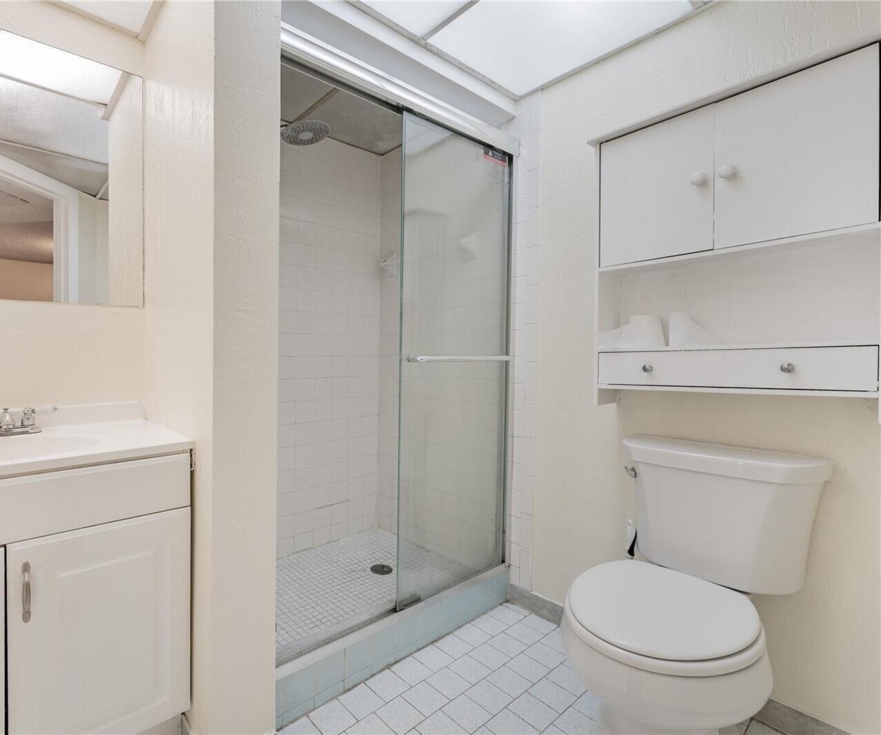 7911 North Colony Circle, Unit 305 Tamarac, FL 33321 - Photo 24 of 49 a white toilet sitting next to a bathroom sink