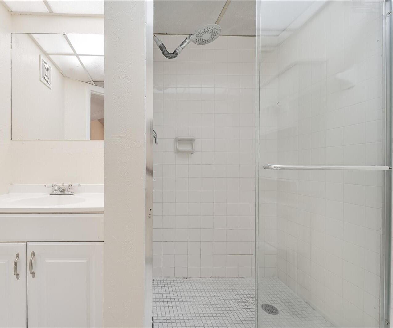 7911 North Colony Circle, Unit 305 Tamarac, FL 33321 - Photo 25 of 49 a bathroom with a shower and a sink