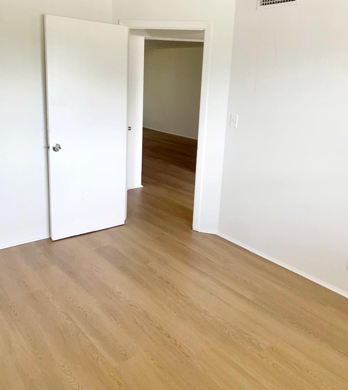 7911 North Colony Circle, Unit 305 Tamarac, FL 33321 - Photo 33 of 49 a view of a hallway with wooden floor