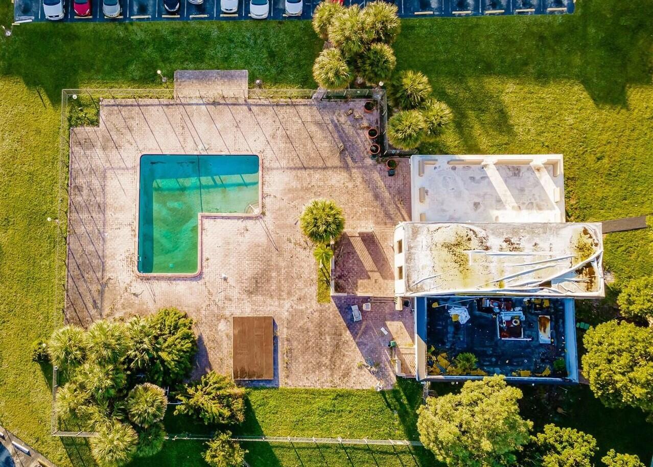 7911 North Colony Circle, Unit 305 Tamarac, FL 33321 - Photo 5 of 49 an aerial view of a house with a yard and garden