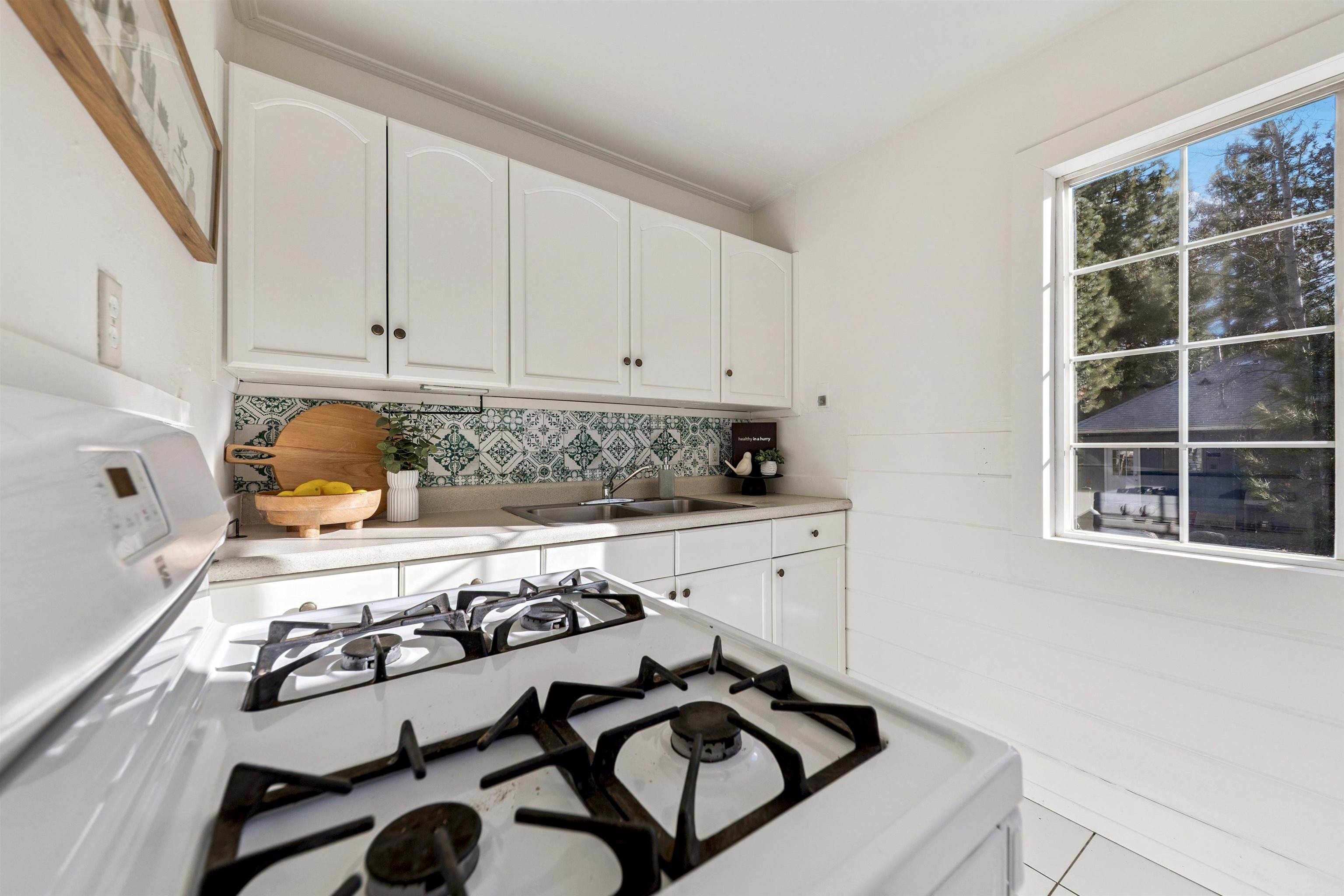 13607 Moraine Road Truckee, CA 96161 - Photo 17 of 28 a kitchen with a stove a sink and a microwave