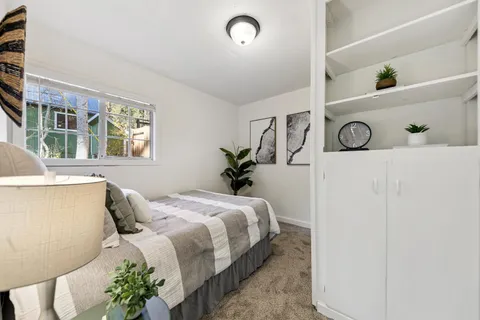 a bedroom with a bed and a window