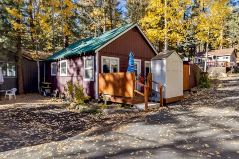 a view of a blue house with yard and windows