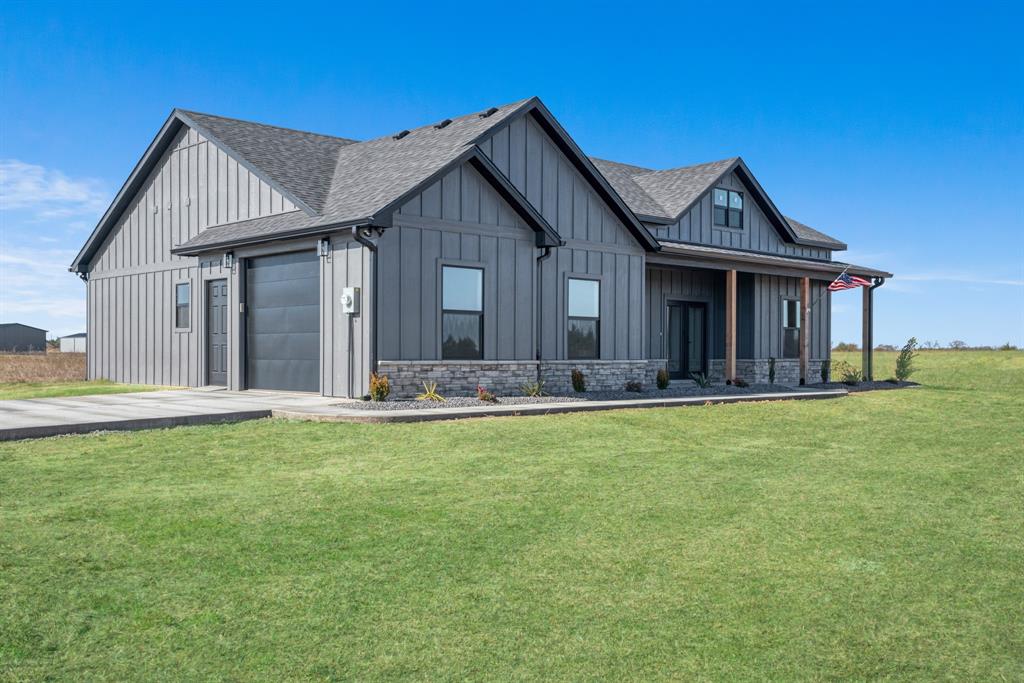 a front view of house with yard patio and fire pit