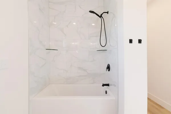 a bathroom with a bath tub and shower