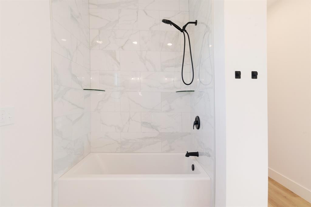 213 Private Road Sumner, TX 75486 - Photo 11 of 19 a bathroom with a bath tub and shower