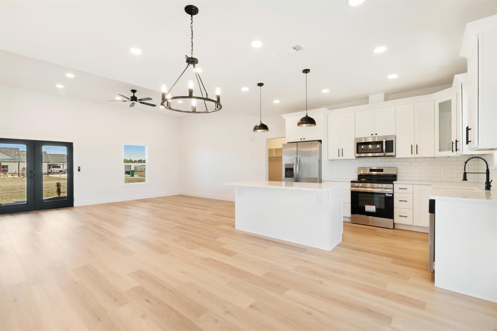 213 Private Road Sumner, TX 75486 - Photo 14 of 19 a kitchen with stainless steel appliances granite countertop a refrigerator a oven and a white cabinets