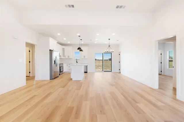 a view of a kitchen with refrigerator and a sink