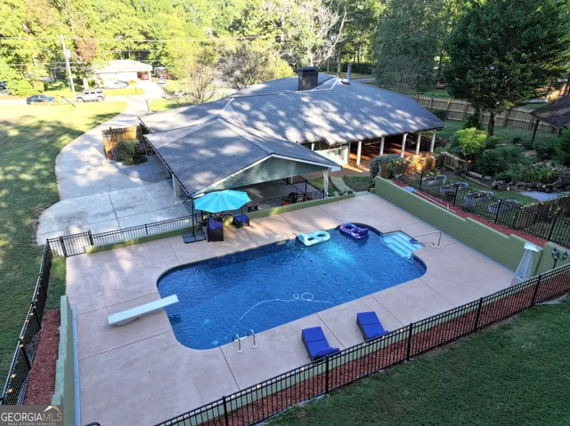 a view of patio with table and chairs under an umbrella